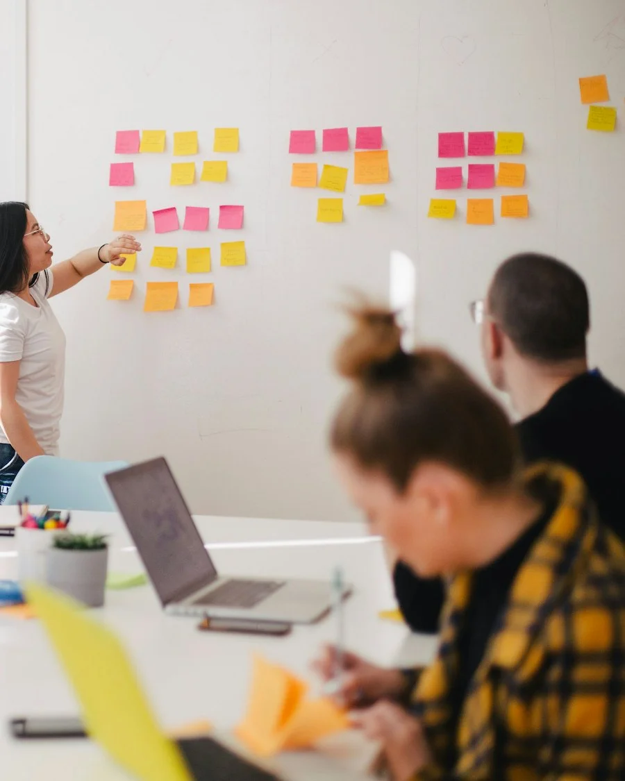 Team planning a cloud strategy on a whiteboard with sticky notes