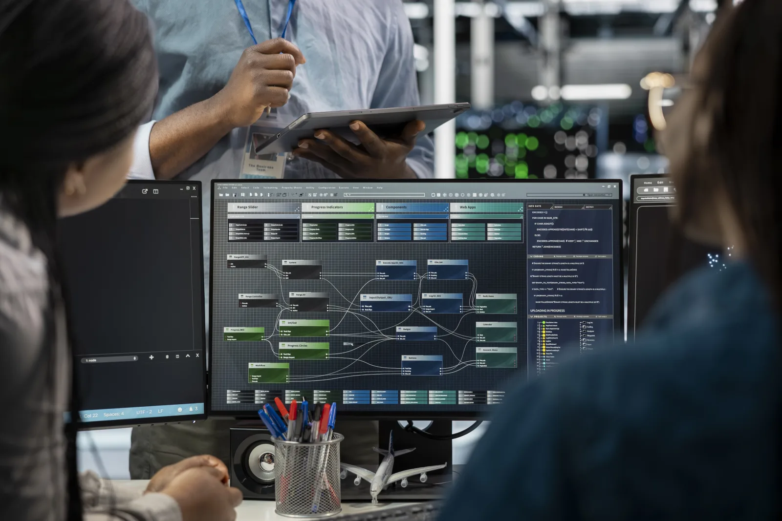Team reviewing an automated workflow diagram on a monitor