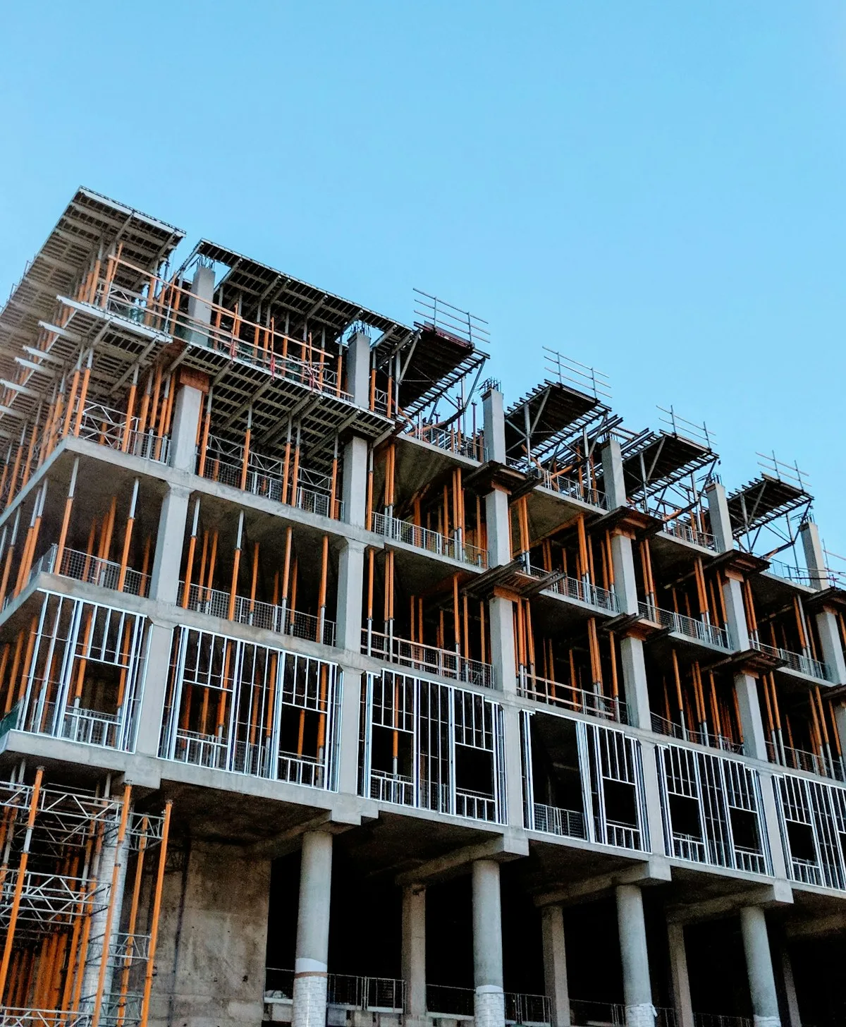 Building frame under construction against a blue sky